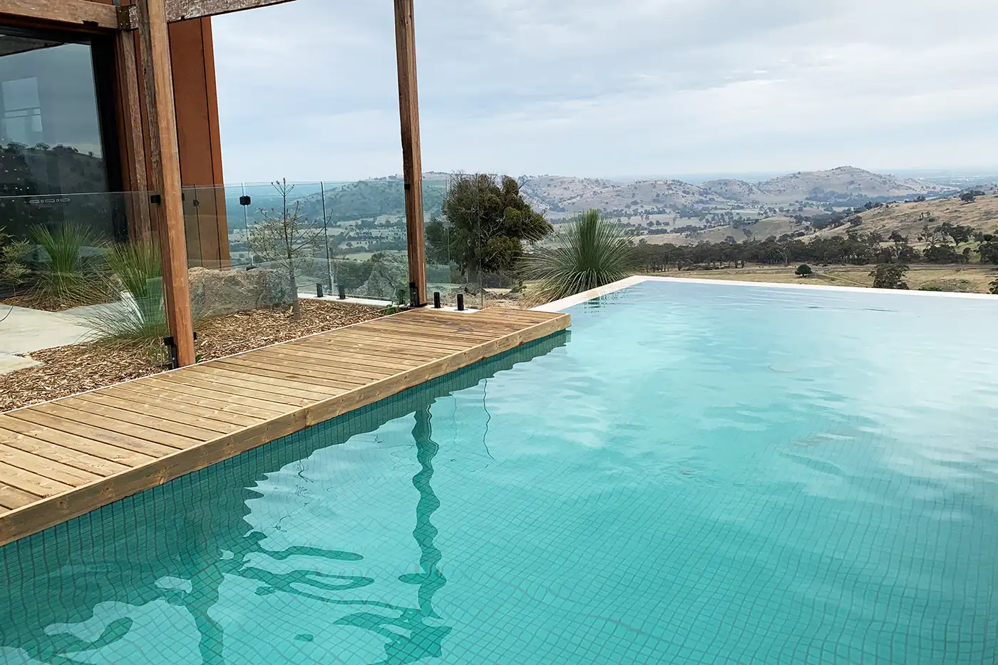 Infinity edge finished in a green tile to compliment the backdrop Concrete Swimming Pools Shepparton, infinity edge, finished in a green tile to compliment the backdrop