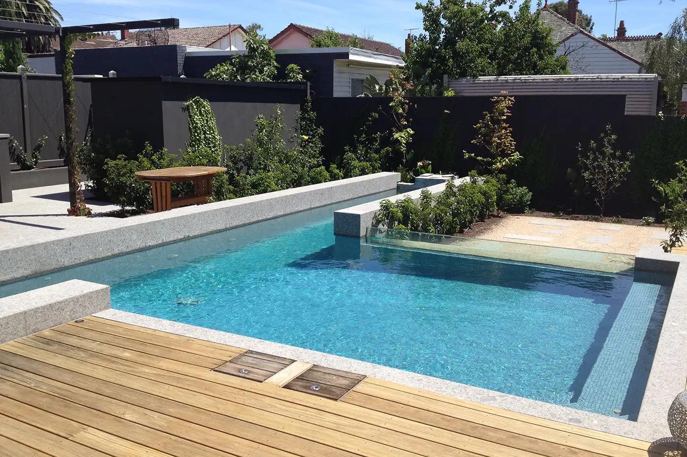 Lap pool with raised coping and acrylic window. Concrete Swimming Pools Shepparton, lap pool with raised coping and acrylic window.