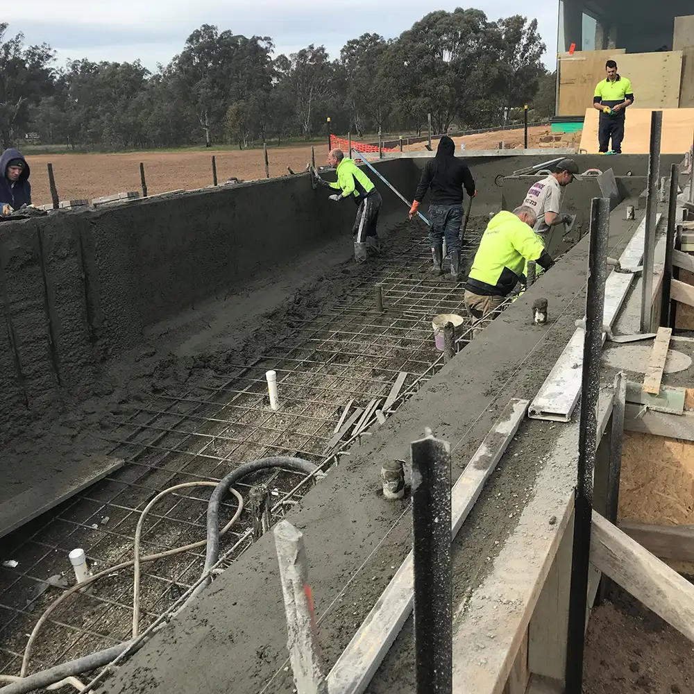 Concrete application to swimming pool frame with smooth troweled finish in Nagambie Victoria