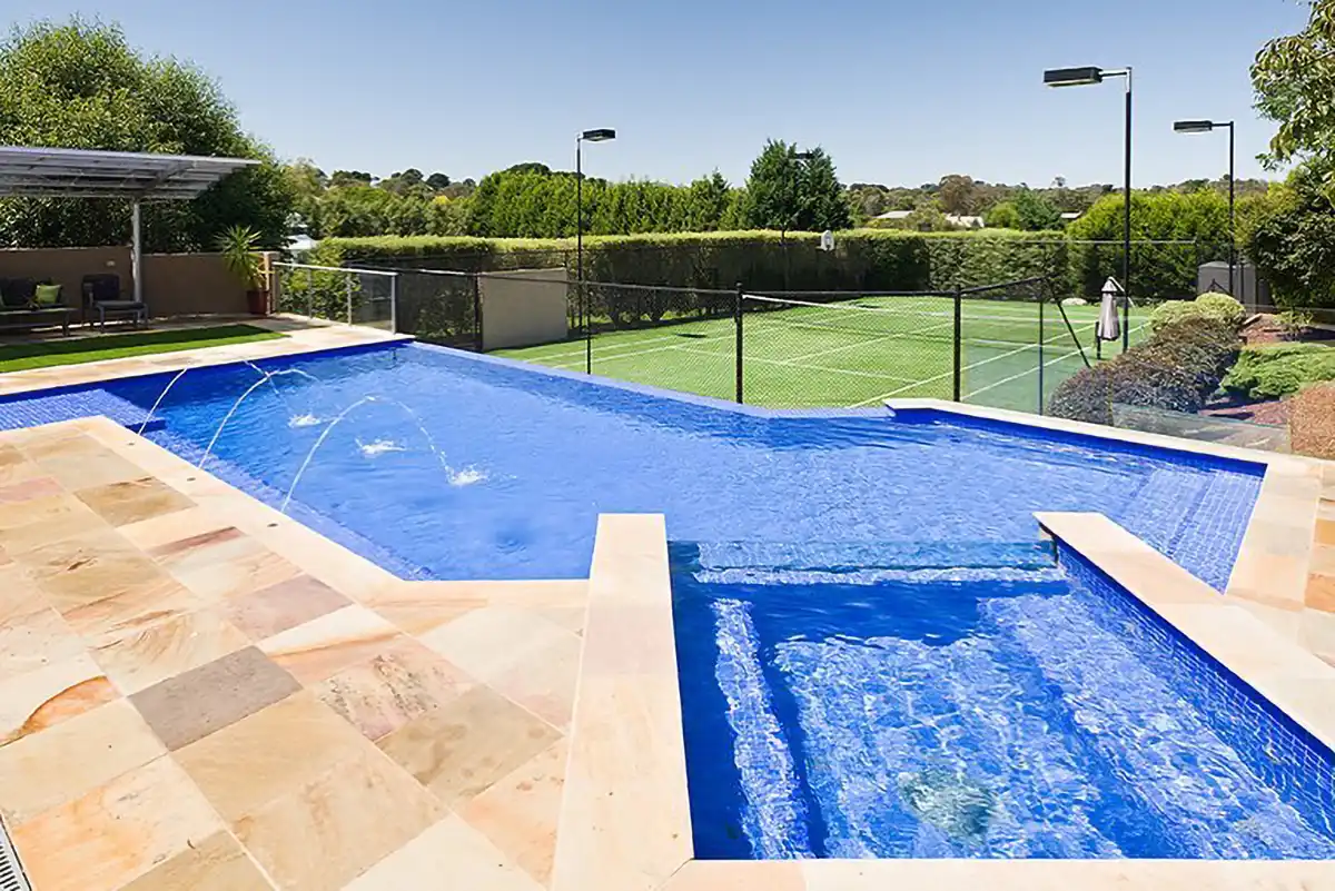 Backyard resort with raised spa overlooking tennis court with infinity edge pool Backyard resort with raised spa overlooking tennis court with infinity edge pool