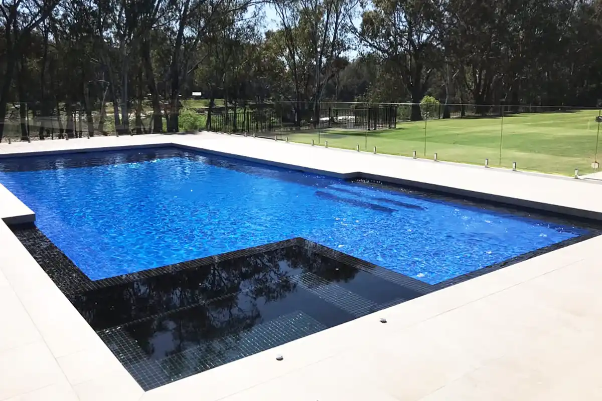 Large family pool with spa and external steps tiled in blue tiles with contrasting black tiled spa Large family pool with spa and external steps tiled in blue tiles with contrasting black tiled spa